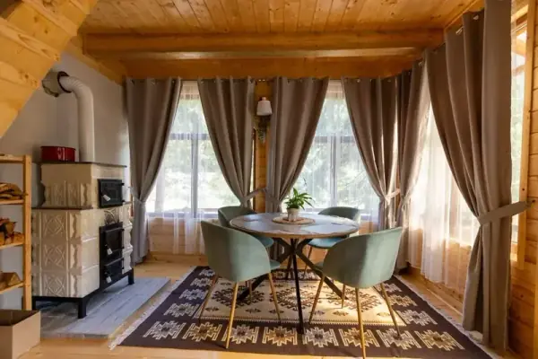 Cozy interior of Pura Vida Forest Home — warm rustic living space inside the mountain forest cabin