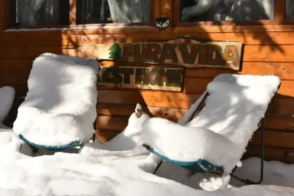Winter view of Pura Vida Forest Home — snow-covered Carpathian forest retreat in Poiana Horea, Cluj, Romania